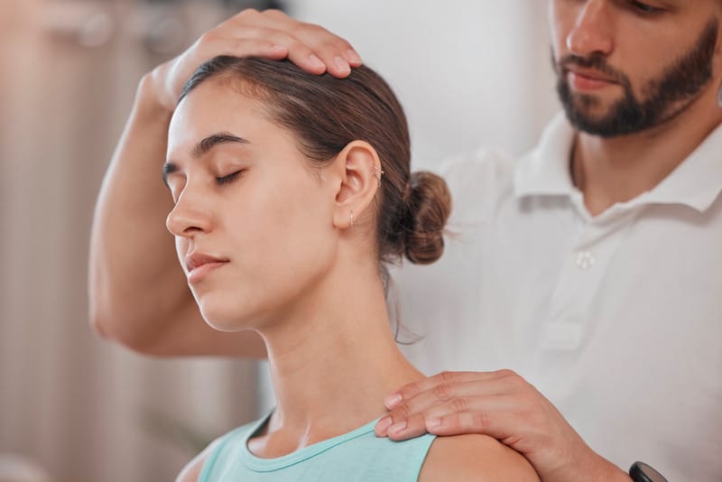 Woman doing a slow side neck stretch instead of forcefully cracking her neck