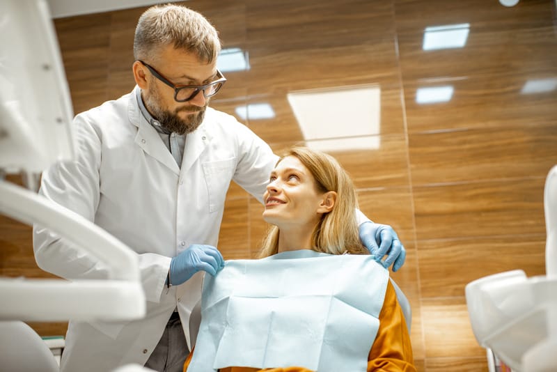 Dentist removing tartar from a patient's teeth during a professional cleaning