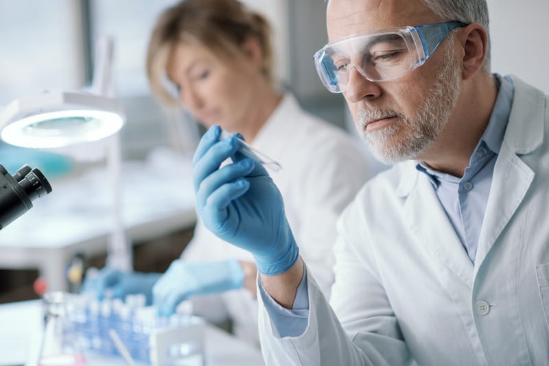 Laboratory researcher holding a sample tube used for nicotine and cotinine testing