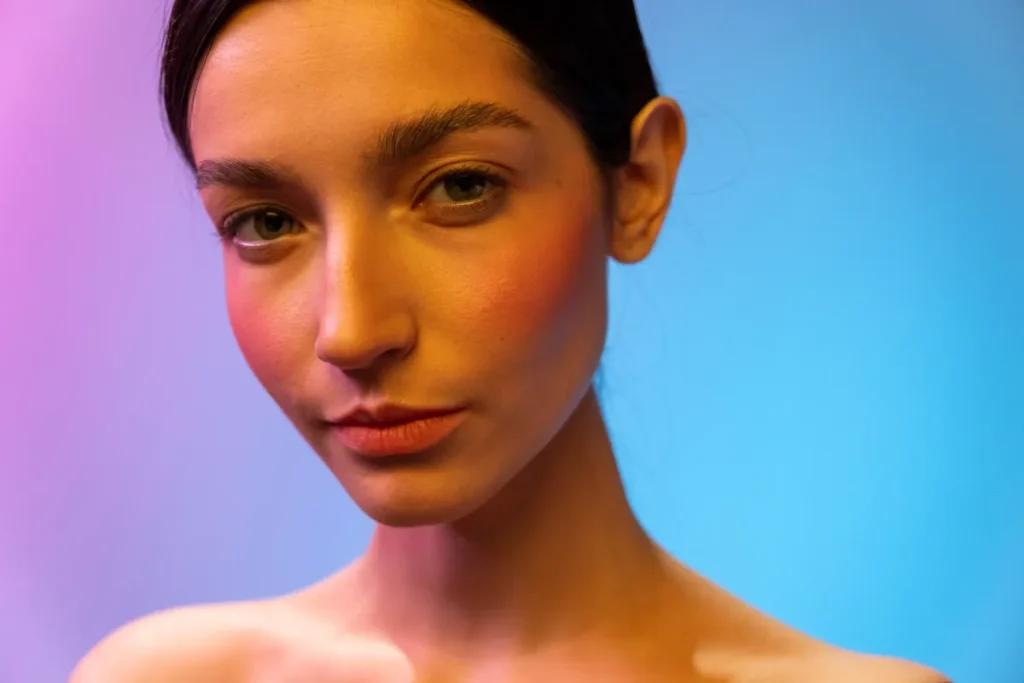 Woman with healthy glowing skin demonstrating natural anti-aging skincare basics