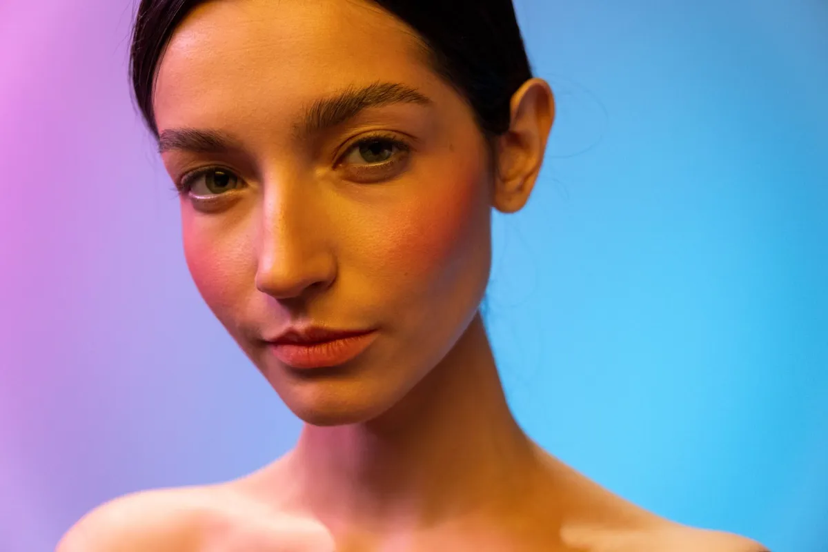 Woman with healthy glowing skin demonstrating natural anti-aging skincare basics