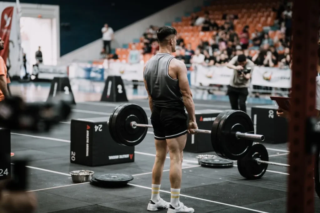Man holding his lower back in pain after a gym workout session