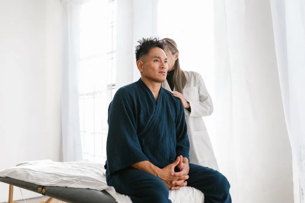 Physical therapist assessing a patient's back pain after exercise