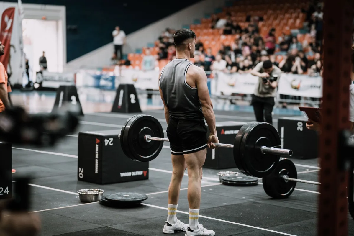 Man holding his lower back in pain after a gym workout session