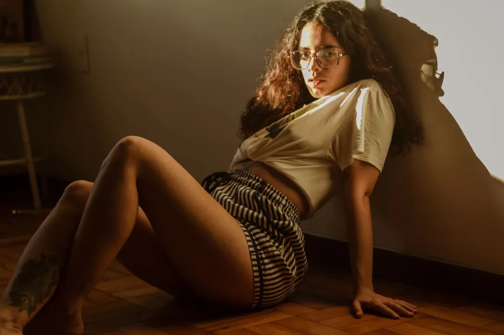 Person sitting cross-legged on floor in morning sunlight starting a meditation practice