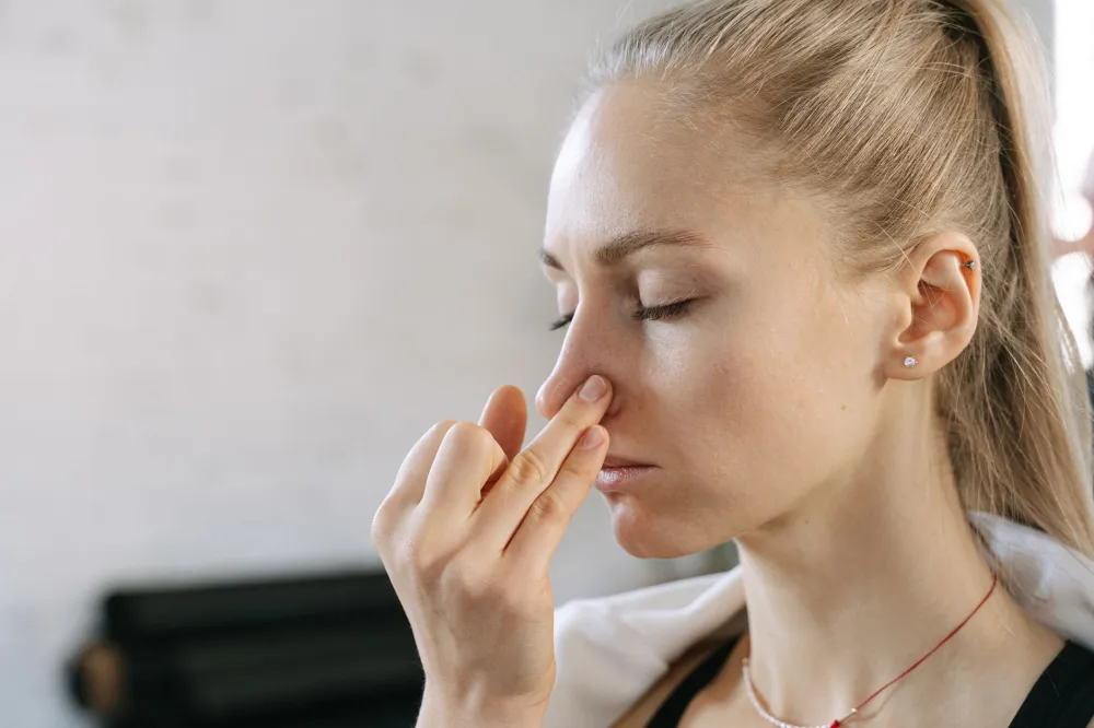 Person pinching nose and swallowing to equalize ear pressure using Valsalva maneuver