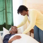 CBD & THC Oil for Dementia Agitation: What Research Says 31 Caregiver gently holding hand of elderly dementia patient in calm room