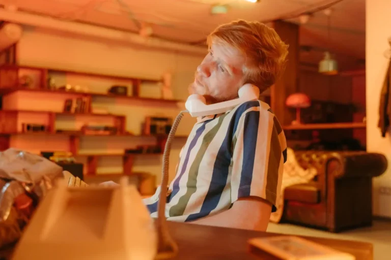Person slouching at office desk experiencing back pain from poor sitting posture