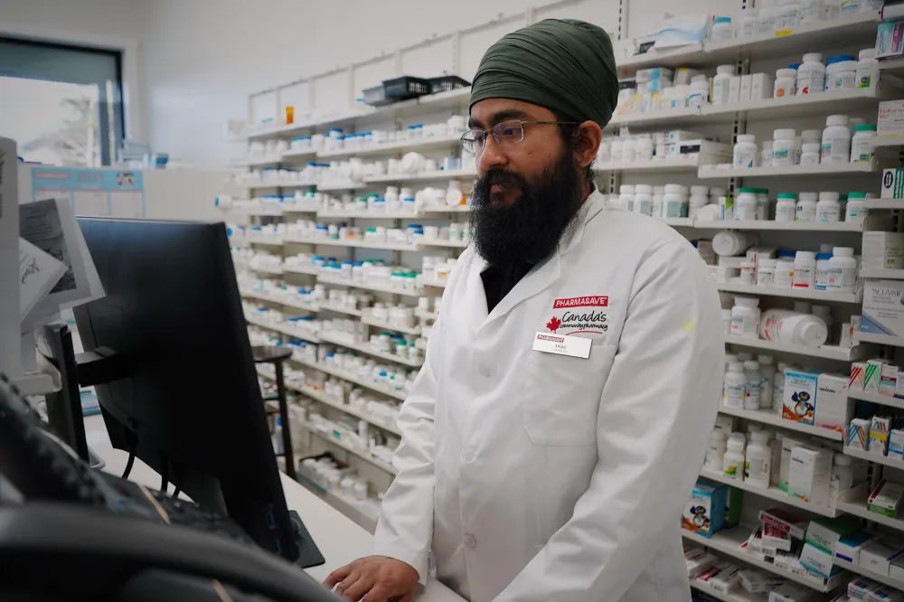 Pharmacist explaining diabetes medication options to a patient at the counter