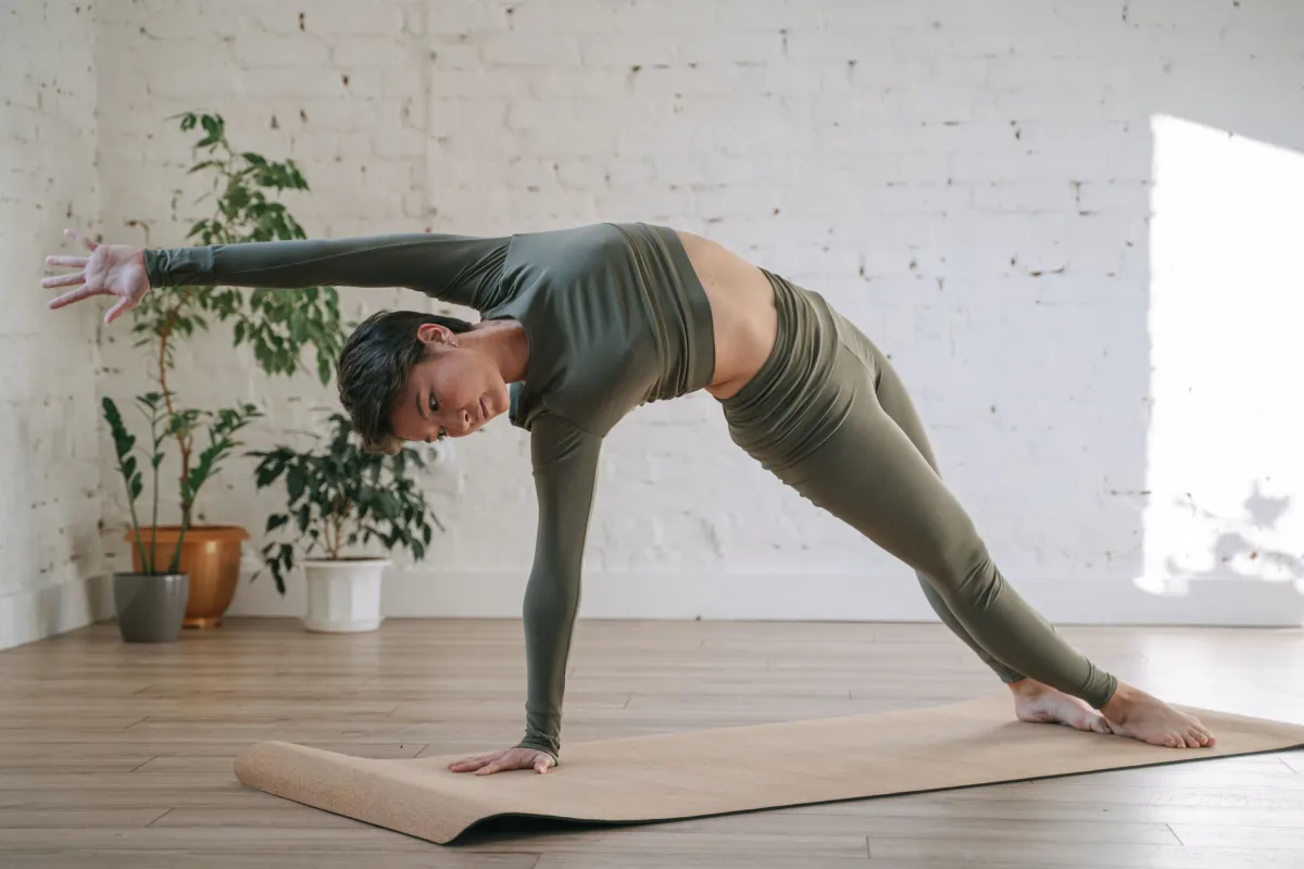 Woman over 40 doing a seated yoga forward fold to improve flexibility