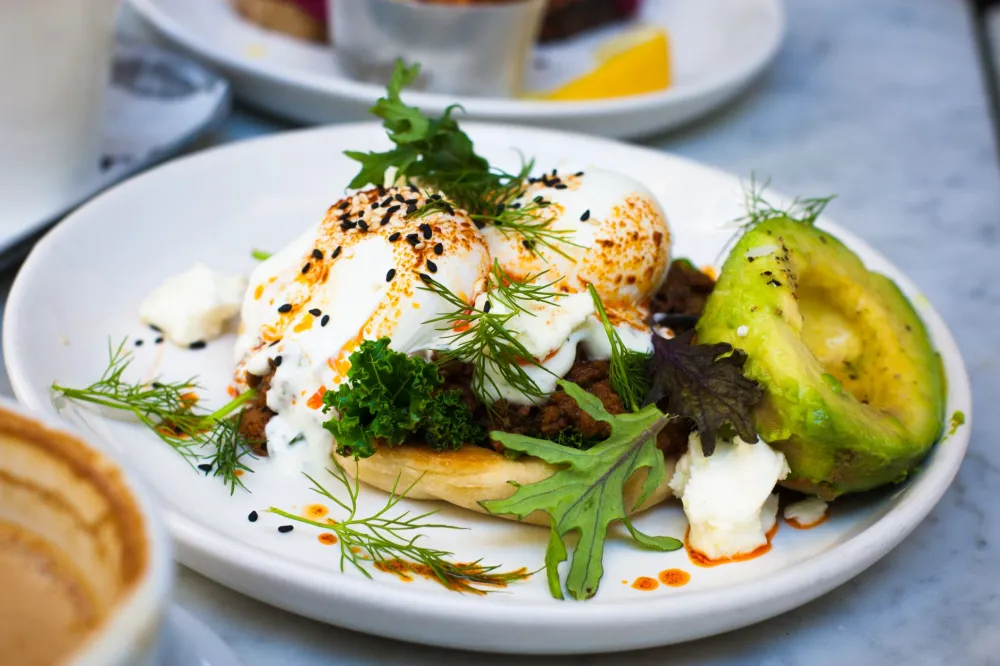 Keto breakfast plate with avocado fried eggs and spinach for 28 day keto plan