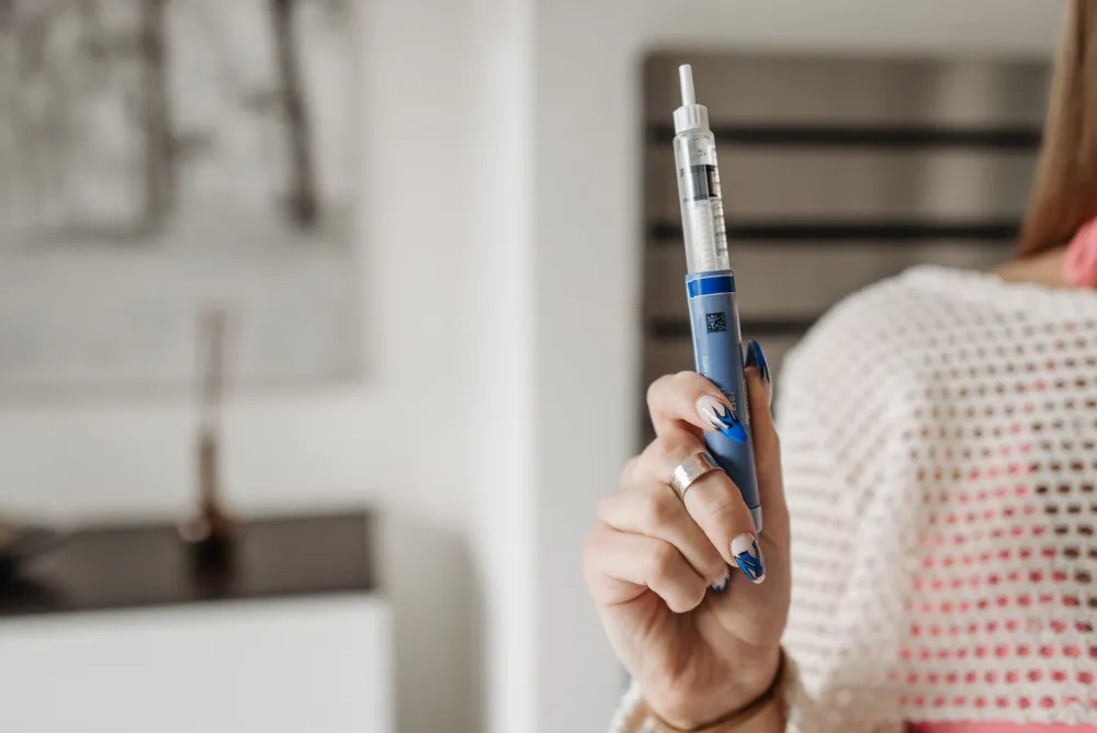 Close-up of a GLP-1 injection pen used for weight loss and diabetes treatment
