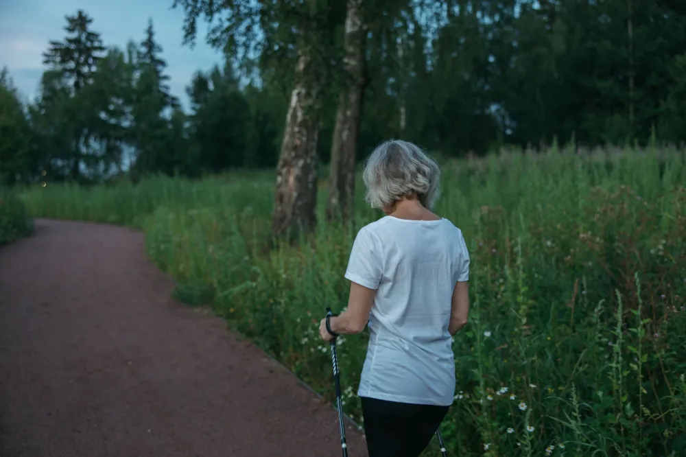 Woman walking outdoors to support weight management alongside GLP-1 therapy