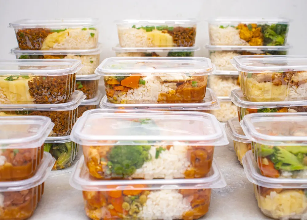 Colorful meal prep containers showing healthy food alongside GLP-1 weight loss lifestyle