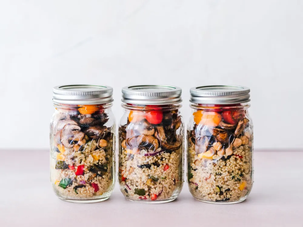 Colorful meal prep containers with balanced nutrition for breaking an intermittent fast