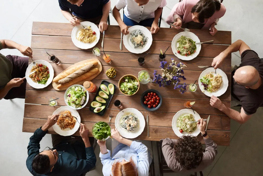 Family sharing a relaxed home-cooked meal together around a dinner table