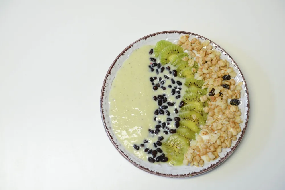 Colorful smoothie bowl with fruit and seeds alongside a morning wellness routine