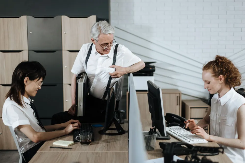 Office worker hunching over laptop screen showing poor neck posture