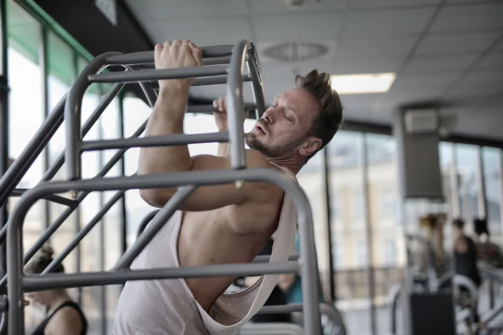 Person performing chin tuck neck stretch exercise seated at chair