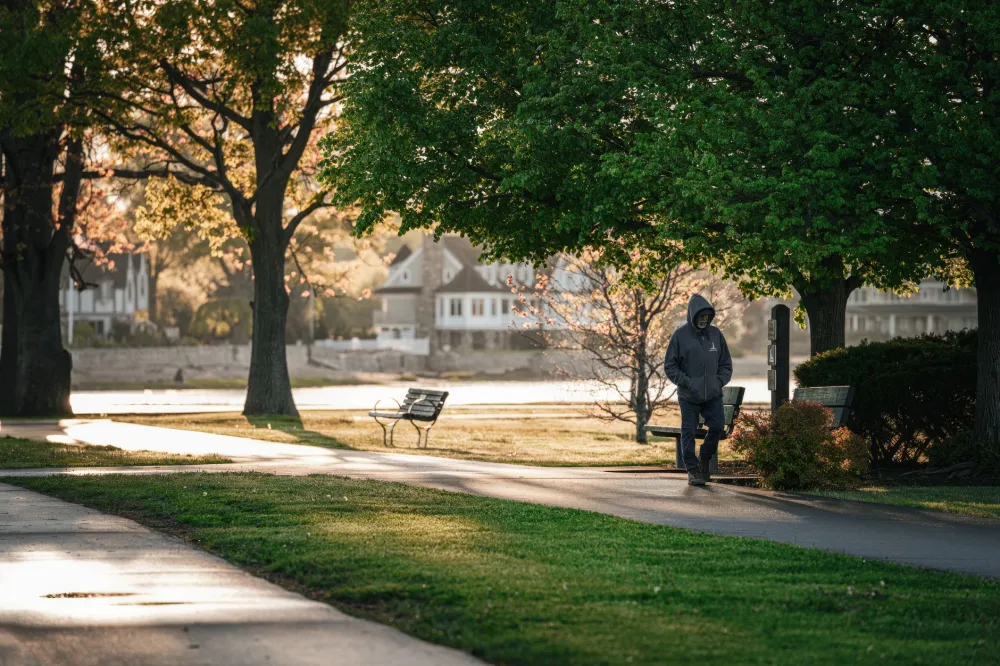 Man jogging through a neighborhood in the morning to support cardiovascular and brain health