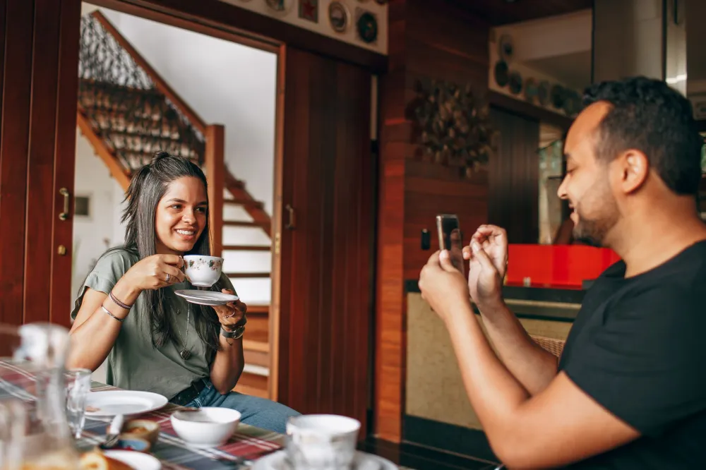 Friends laughing over coffee, illustrating how social connection may help reduce dementia risk