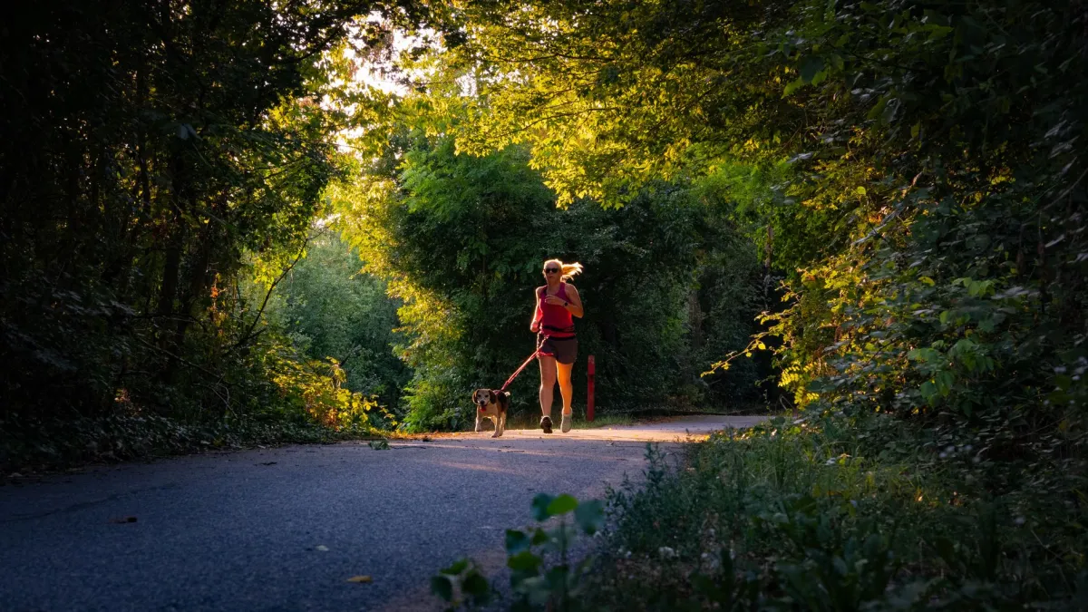Woman walking outdoors in morning sunlight practicing daily longevity habits