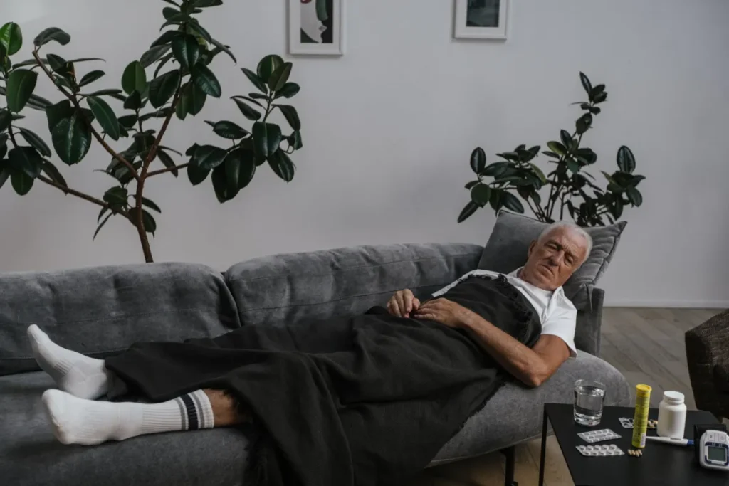 Person resting on a couch at home during stomach bug recovery