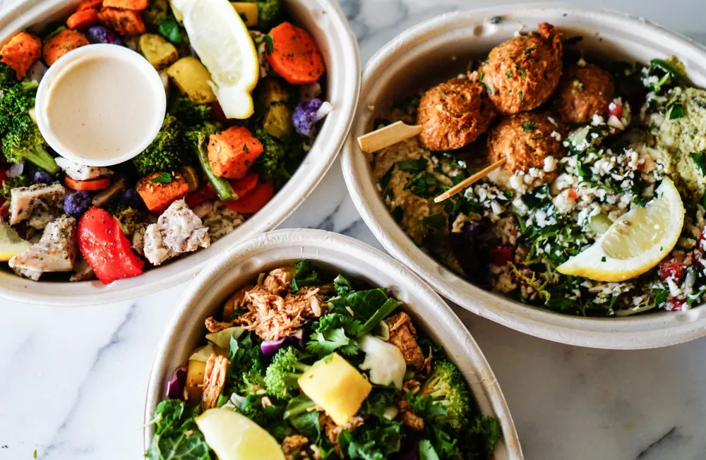 Colorful meal prep bowls with vegetables, fiber, and protein for digestive wellness