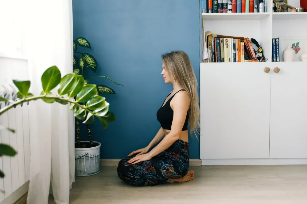 Woman practicing relaxation techniques in a calm room to manage tinnitus symptoms