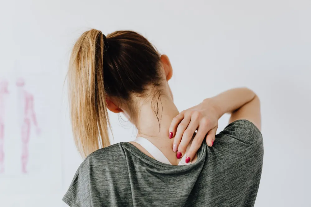 Close-up of a heat pack applied to a stiff neck for pain relief