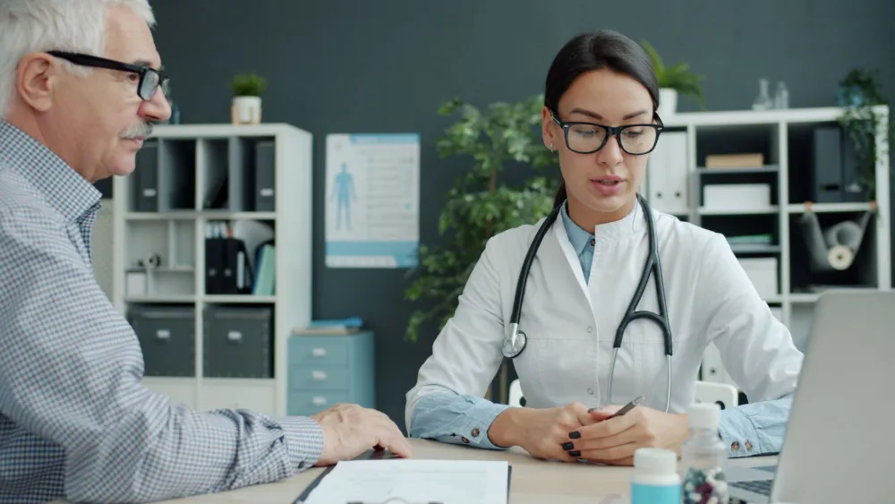 Doctor reviewing a patient's lower back pain and discussing treatment options