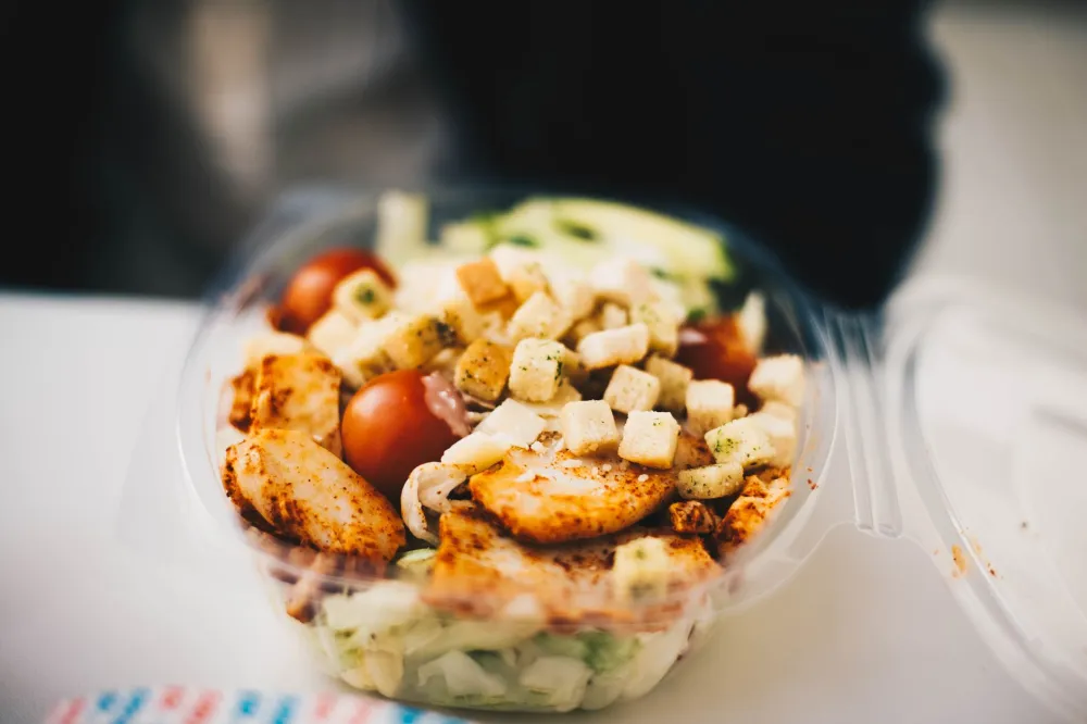 Colorful healthy meal prep containers helping break a weight loss plateau
