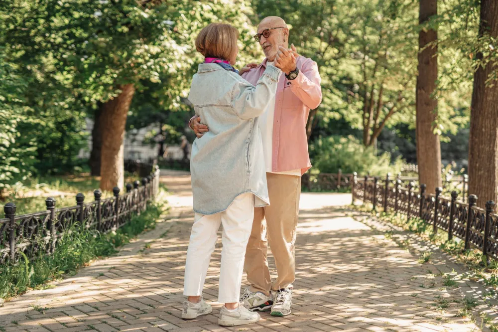 10,000 Steps a Day: What the Science Really Says 3 Two older adults walking together in a sunny park for daily exercise
