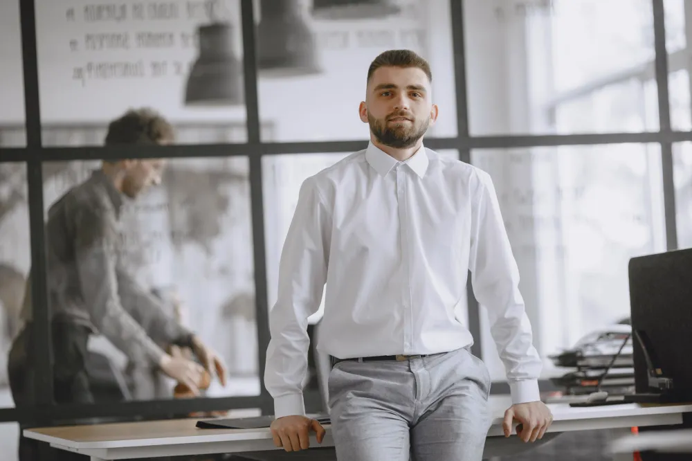 10,000 Steps a Day: What the Science Really Says 4 Office worker standing and stretching at a standing desk to break sitting time
