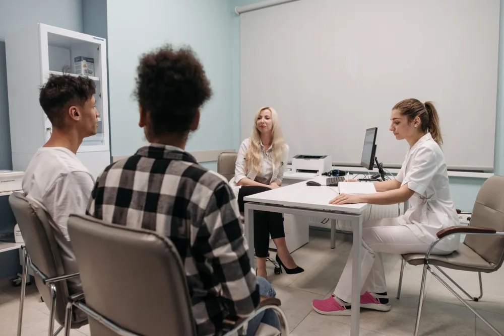 Doctor speaking with patient in community clinic setting about health research access