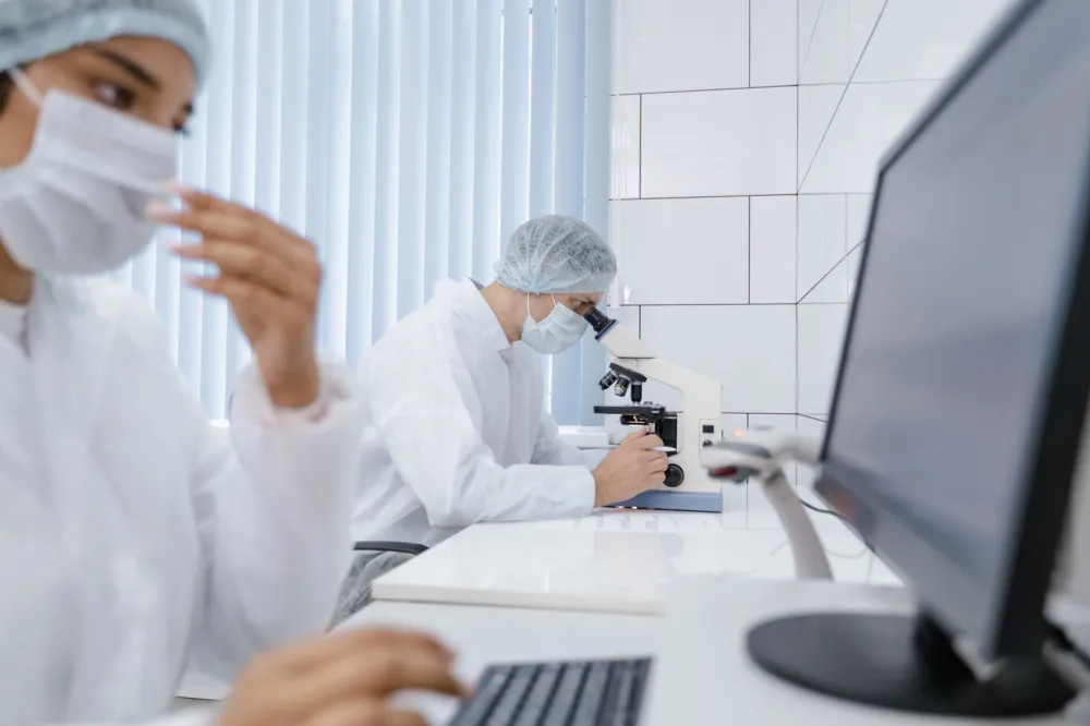 Medical research team reviewing clinical trial data to expand community health participation