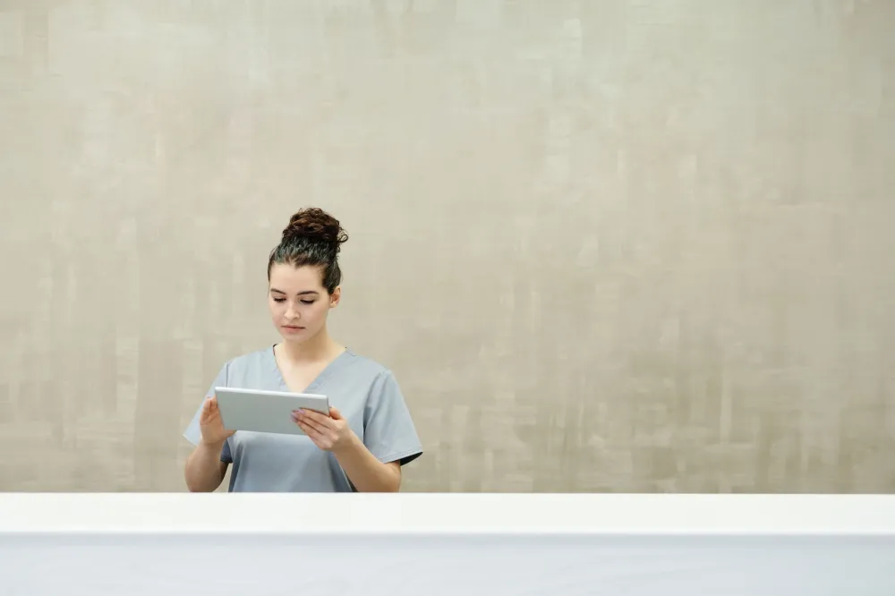 Woman reviewing personal health and clinical trial information on a tablet at home
