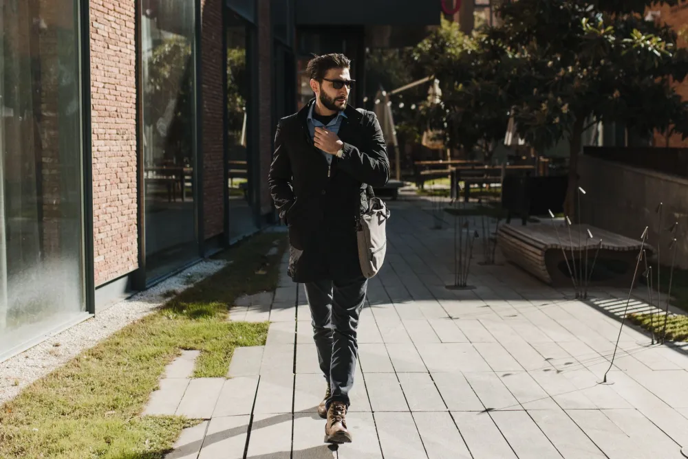 Person taking a brisk walk outside in afternoon sunlight to boost energy