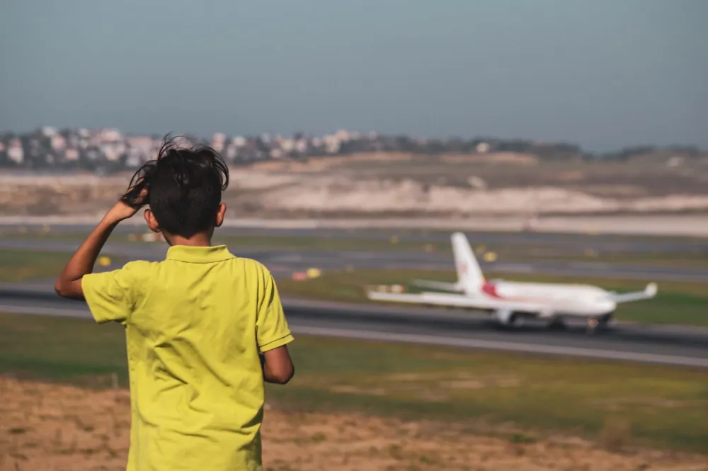 Young child on an airplane with parent, managing ear discomfort during flight descent