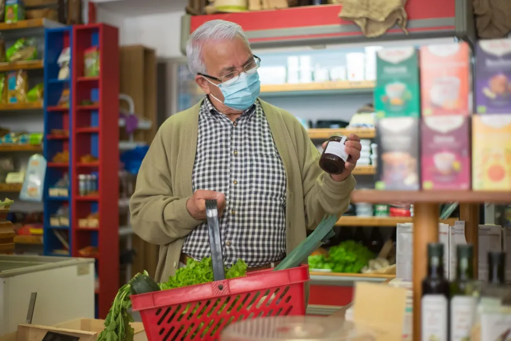 Woman reading nutrition label at grocery store to identify added sugar content