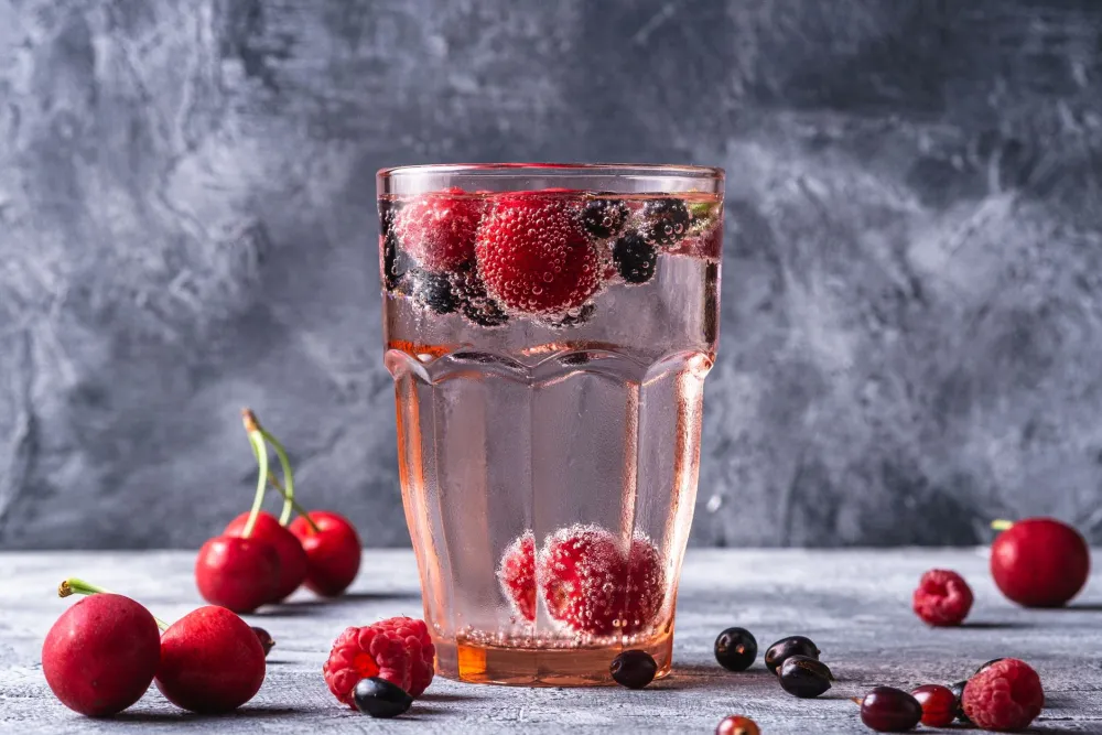 Glass of sparkling water infused with citrus and berries as a soda alternative