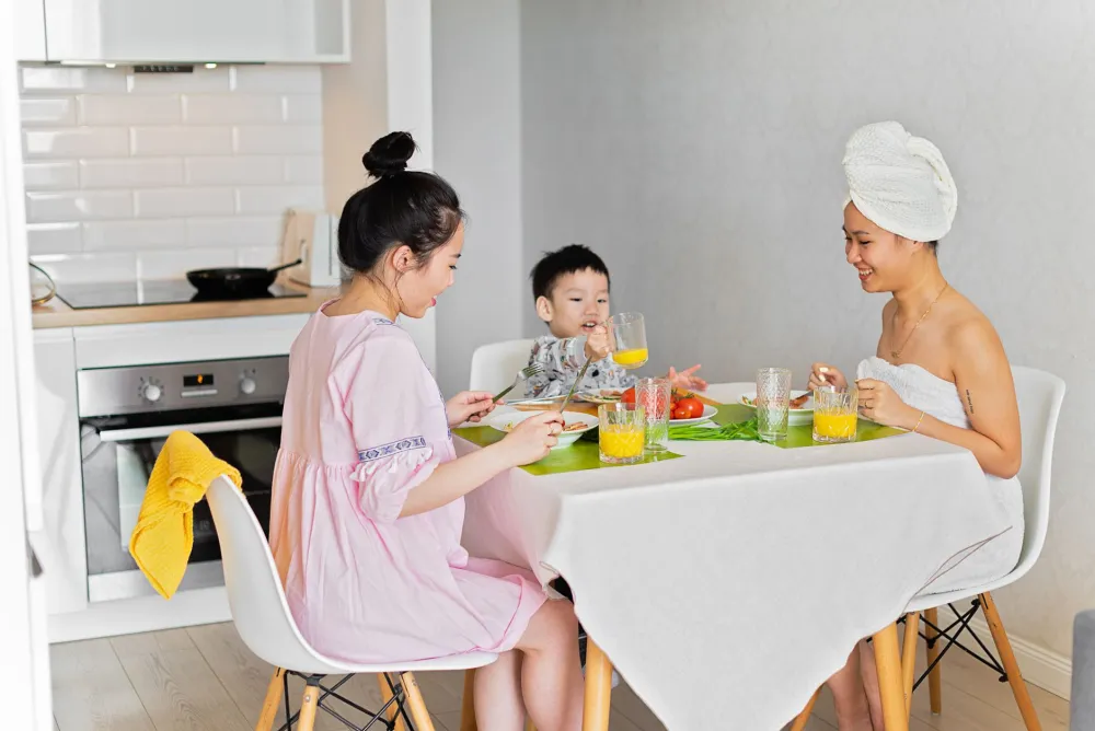 Family sharing a calm morning breakfast routine before a later school start time