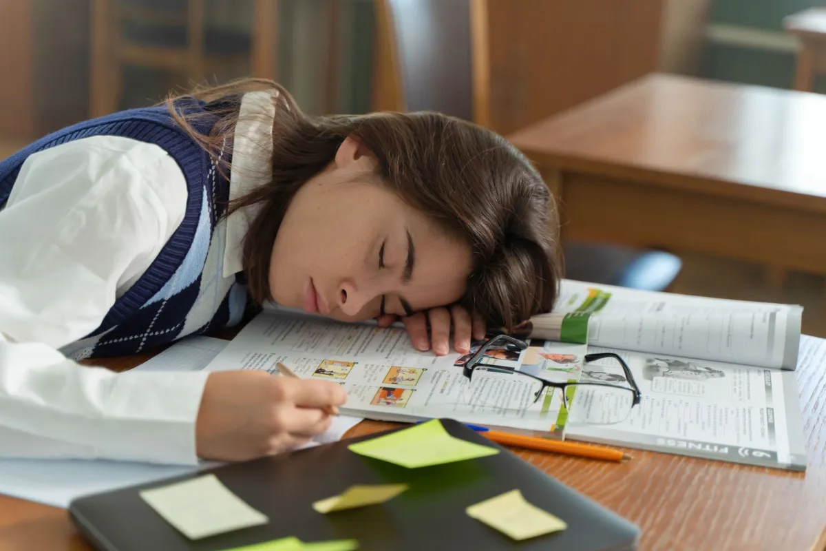 Tired teenage student struggling to wake up early for school on a weekday morning