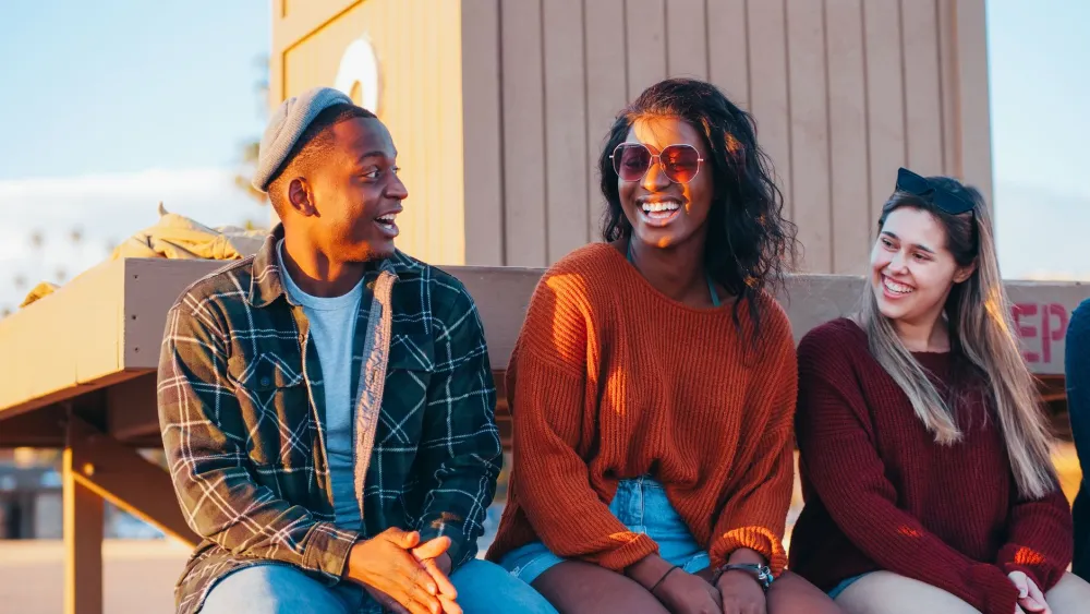 Light Drinking & Brain Health: What the Research Really Says 5 Group of friends laughing together at a social gathering linked to better brain health