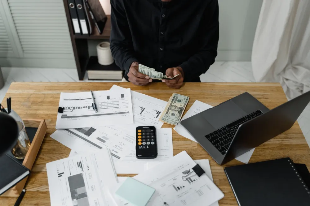 Person using laptop to plan a healthcare budget and review explanation of benefits