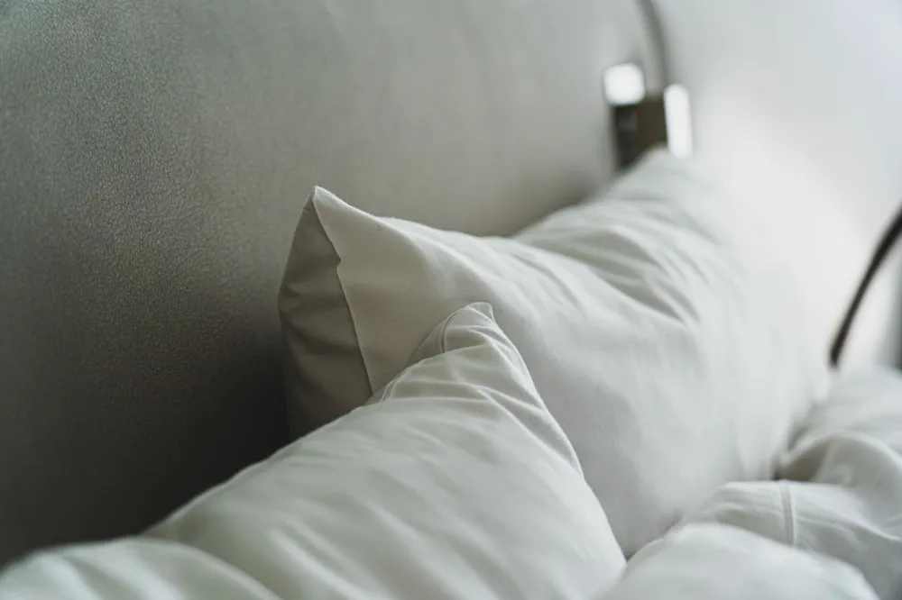 Different types of bed pillows lined up showing loft and fill options for neck pain relief