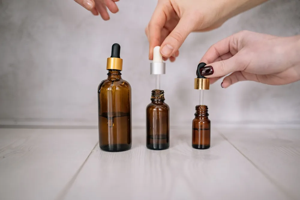 close-up of a vitamin C serum dropper bottle for correct skincare layering order