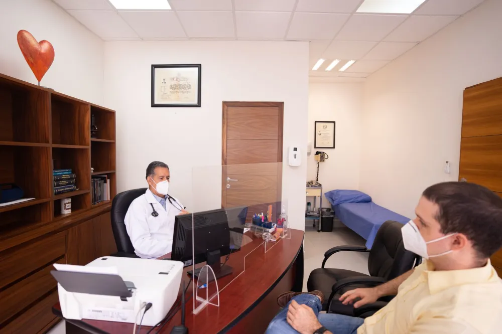 Doctor reviewing sciatica symptoms with a patient during a clinic consultation