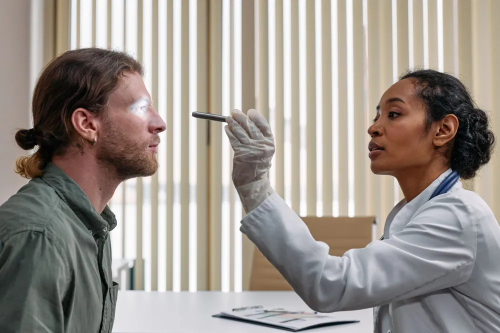 Doctor examining a patient's nasal passage during an ENT health consultation