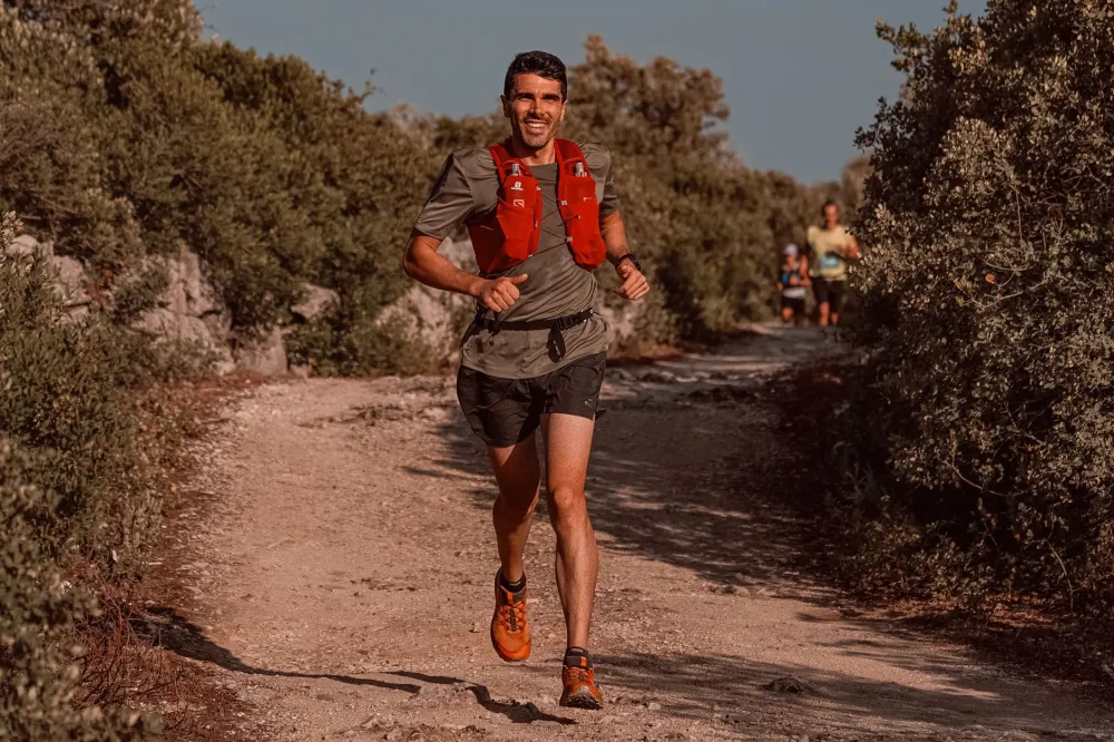 Man running on an outdoor trail showing cardio exercise for weight loss